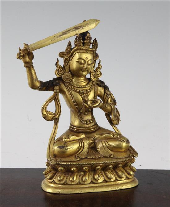 A Tibetan gilt bronze figure of Manjushri, 18cm